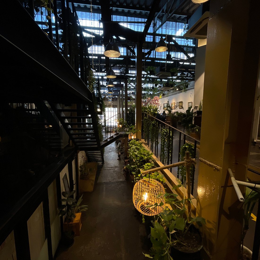 Baan Saen Saep cafe in Bangkok, two-story plant-filled wooden house interior